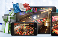 An illustration of a roulette wheel on multiple devices, the French flag, casino chip stacks, wads of Euros on a blue background