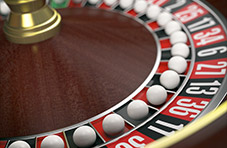 close up image of a roulette wheel with a ball in every spot.