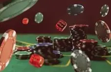 two dice and chips on a poker table flying around