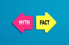 The words myth and fact in a pink and yellow arrow pointing in opposite directions on a blue background