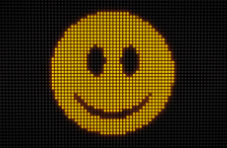 A retro-style image of a yellow pixelated smiley face on a dark pixelated background
