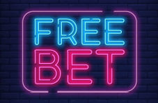 An illustration of a pink and blue neon sign with the words FREE BET on a dark brick wall background
