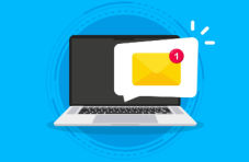 An image of a laptop with a yellow envelope in a white speech bubble coming from the blank screen on a blue background