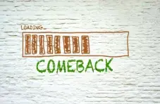 An illustration of a loading bar with the word “comeback” written below on a white brick wall background