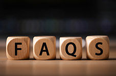 four small wooden blocks with the letters F-A-Q-S written on them.