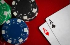 playing cards and poker chips on a red poker table