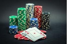 big pile of coins in the middle of a poker table