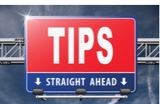 a highway road sign that says TIPS Straight Ahead