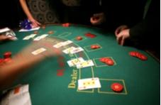 people playing blackjack at a land-based casino