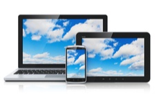 laptop screen, tablet and phone screens with sky and clouds on the screens