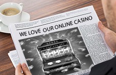 Newspaper with the headline "We Love Our Online Casino"