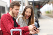 a man and a women playing together on a mobile device