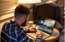 man playing Poker Online on his laptop