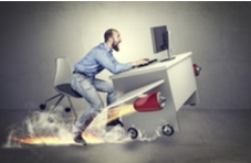 man sitting at his computer desk as jets take off moving him forward