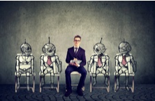 a man sitting with four robots seemingly waiting for job interviews