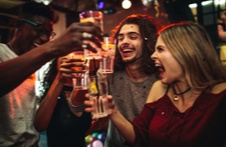 men and women having a toast in a bar