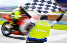 motorcycle race with a checkered flag waving in the winner