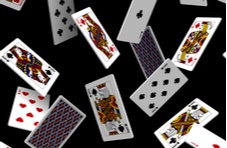 Multiple playing cards falling on a black background
