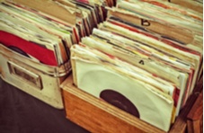 Two old storage containers filled with vintage vinyl records