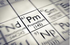 A close up of the periodic table focusing on Promethium, displaying the element’s symbol (Pm), atomic and mass number