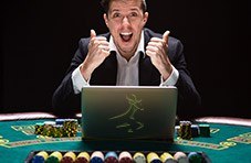 Player playing a Springbok video poker game on his laptop