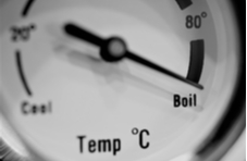 photo of a round temperature gauge showing degrees in Centigrade with the dial on the word Boil