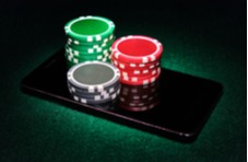 stacks of real casino chips sitting on a smartphone