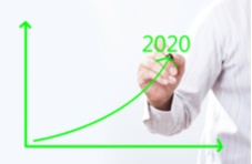 business man drawing an upward graph with 2020 written on it