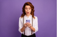 woman playing online blackjack at Springbok Casino with a purple background