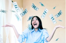 happy woman with dollar bills falling down on her