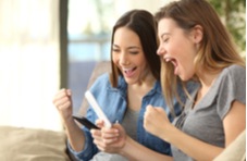 two women happily playing on their phones together