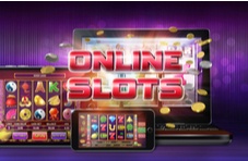 the words Online Slots over a laptop, tablet and mobile phone with a slots game on them