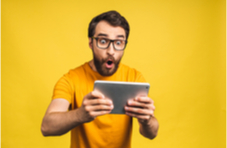 young bearded man excited about a win on his mobile phone